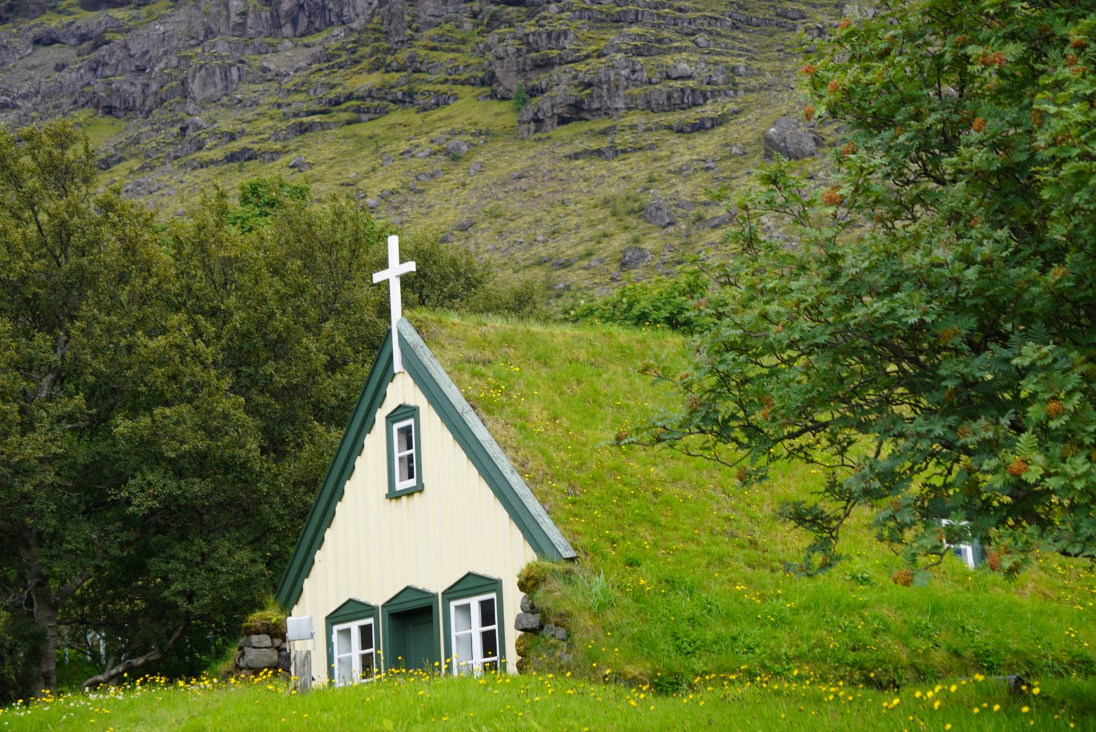 A turf church in a green valley, Iceland.
